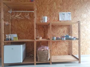 a wooden book shelf with two levels and a basket at comme chez nous 