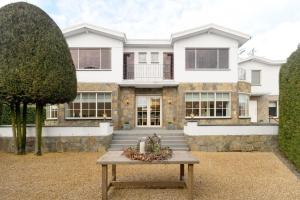 a house with a table in front of it at Villa Op de Voort (XL, 12-22 personen) in Heusden - Zolder