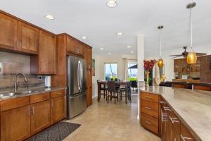 une cuisine avec des placards en bois et une salle à manger dans l'établissement 5N-53 Beach Bliss Ocean Views, à Oceanside