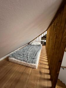 a bed sitting on the floor next to a staircase at Arbor in Vadul lui Carol II +3 photos