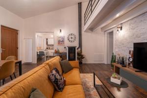 a living room with a couch and a dining room at 3 MURA rooms in Teulada