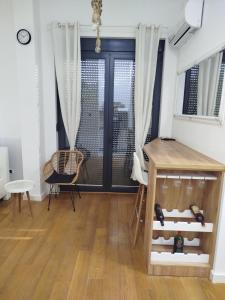 a room with a door and a table and chairs at Xenia in Petrovaradin