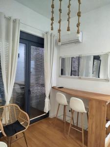 a dining room with a wooden table and white chairs at Xenia in Petrovaradin