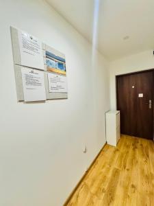 a white room with a door and a wooden floor at Pokoje przy Rynku III in Katowice