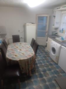 a kitchen with a table and chairs in a kitchen at Cozy King Room with Shared Kitchen & Bathroom in Lewisham +3 photos