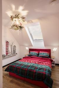 a bedroom with a red bed and a skylight at Domki u Duszy in Brenna