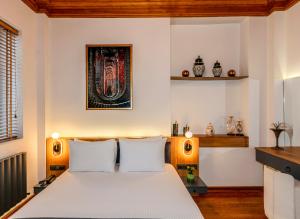 a bedroom with a white bed with two lamps at Elmoria Pera In Hotel in Istanbul