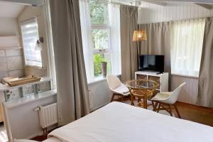 TV a/nebo společenská místnost v ubytování Texel Tuinkamer