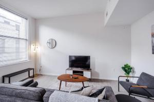 a living room with a couch and a table at TWO CozySuites Sky Central Rooftop Pool #25 in Cincinnati