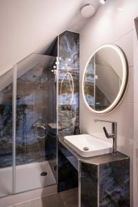 a bathroom with a sink and a mirror at Domki u Duszy in Brenna