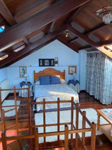 a bedroom with a bed in a room with wooden ceilings at La Quintana del Sol in Aramil de Arriba
