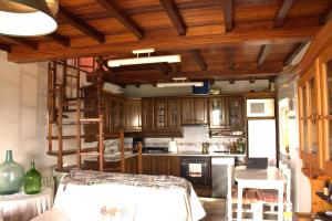 a kitchen with wooden cabinets and a stove top oven at La Quintana del Sol in Aramil de Arriba