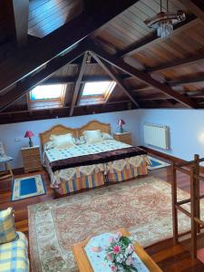 a bedroom with a bed in a room with windows at La Quintana del Sol in Aramil de Arriba +13 photos