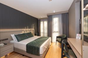 a hotel room with a bed and a desk and a desk at QUİ Hotel&SPA in Istanbul +75 photos