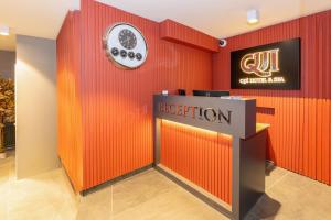 a reception area of a hotel with a red wall at QUİ Hotel&SPA in Istanbul