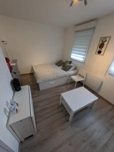 a small room with a bed and a table at City Break Arras in Arras +12 photos