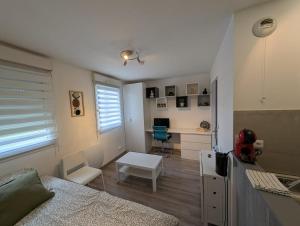 a bedroom with a bed and a desk with a computer at City Break Arras in Arras