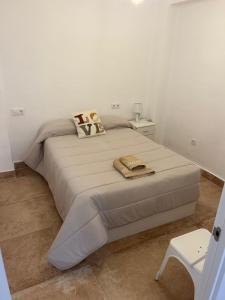 Postel nebo postele na pokoji v ubytování Las Arenas del Coliseo