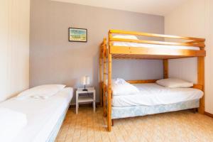 En eller flere senge i et værelse på Maison Cri-Cri à Arès