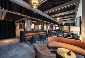 a restaurant with couches and tables and chairs at The Square in Copenhagen