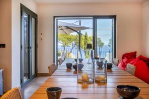 a dining room table with a view of a patio at Cala Nostra Bea in Palafrugell