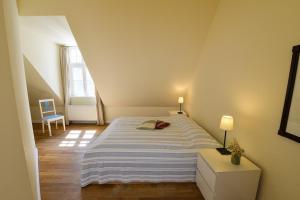 a bedroom with a large bed in a attic at Wohnung Im Zweiten Obergeschoss Des Gutshauses in Neuenkirchen +10 photos