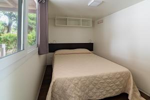 Postel nebo postele na pokoji v ubytování Villaggio Camping Spiaggia Lunga