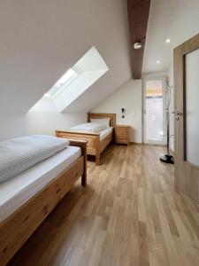 a attic bedroom with two beds and a skylight at Bergnescht - Dein Wohnfühlort im Schwarzwald in Todtnauberg