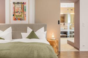 a bedroom with a bed and a living room at Hotel Villa Lago in Bad Wiessee +55 photos