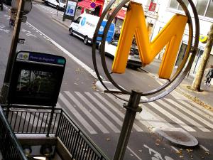 a bus stop sign with the letter n on a city street at Hipotel Belgrand Edith Piaf in Paris