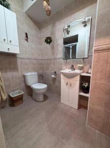 a bathroom with a toilet and a sink at Welcome to your upscale coastal escape! in Tel Aviv