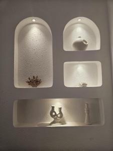 a bathroom sink with three mirrors on a wall at Apartamentos Casa del Mar in Torrevieja