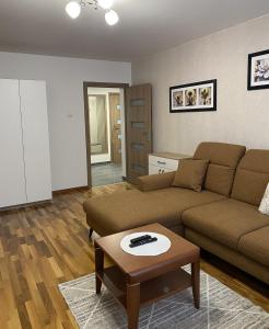 a living room with a couch and a coffee table at Apartament Wysoka Brama in Lidzbark Warmiński