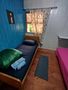 a bedroom with two beds in a blue tent at Quarto N II Cama Individual e sofá cama solteiro in Gramado