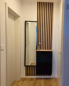 a bathroom with a mirror and a sink at Pfalz Studio in Speyer - stilvoll, modern & zentral in Speyer +9 photos