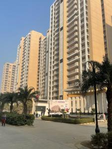 a large building with palm trees in front of it at Vaibhav Stays in Nalmatha