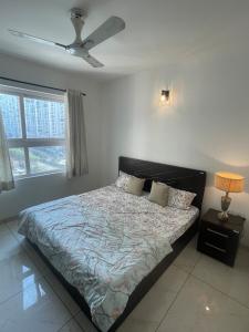 a bedroom with a bed and a ceiling fan at Vaibhav Stays in Nalmatha +15 photos