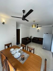 a dining room table with a ceiling fan and a living room at Vaibhav Stays in Nalmatha