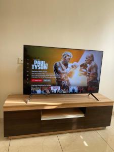 a flat screen tv sitting on top of a wooden table at Vaibhav Stays in Nalmatha