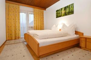 - une chambre avec un lit et des rideaux jaunes dans l'établissement Rundblick 4 Panorama Groß, à Tschagguns