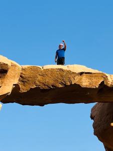 瓦迪拉姆Desert Key Camp的站在岩层顶端的人