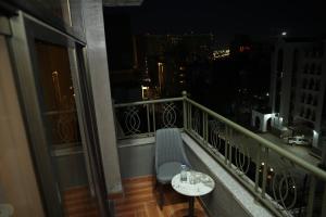 a balcony with a table and a bench on a balcony at Yofel Hotel in Dirē Kʼalu