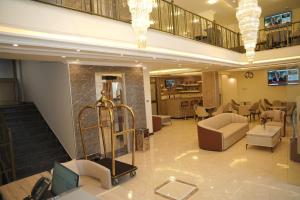 a lobby of a hotel with couches and chairs at Yofel Hotel in Dirē Kʼalu