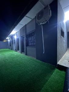 イバダンにあるLOJ Homesの緑の床とバスケットボールのゴールがある部屋