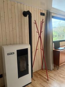 a fireplace in a room with a desk and a laptop at Luxurious houseboat for up to 4 people in Dausenau +8 photos