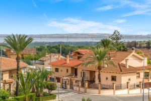 a row of houses with palm trees in a town at Piso Maria in San Miguel de Salinas