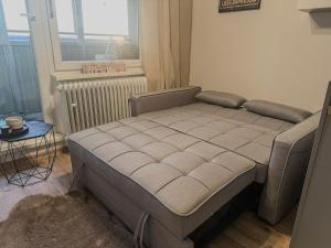 a bed in a room with a window and a table at Klimatizovaný Apartmán - Hodo in Rimavská Sobota