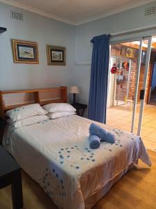 Ένα ή περισσότερα κρεβάτια σε δωμάτιο στο Rus n Bietjie