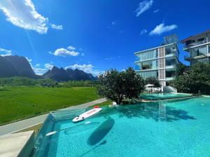a swimming pool with a car on top of a building at Paddy Fields Resort-Guilin Shuidaotian in Yangshuo