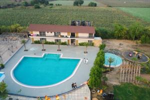 an aerial view of a house with a swimming pool at A1 Tiger Resort in Kolāra